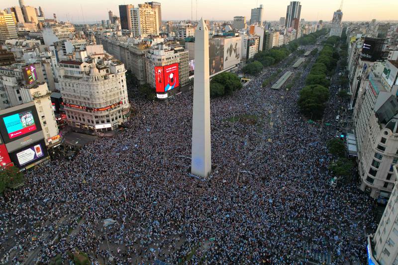 Fans of Argentina celebrate their team's victory after the World Cup semi-final football match between Croatia and Argentina at the Obelisk in Buenos Aires. AFP