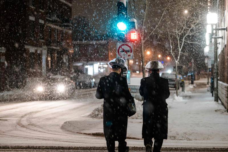 Pedestrians on a snowy street in the Mile End borough of  Montreal, in Quebec, eastern Canada. AFP