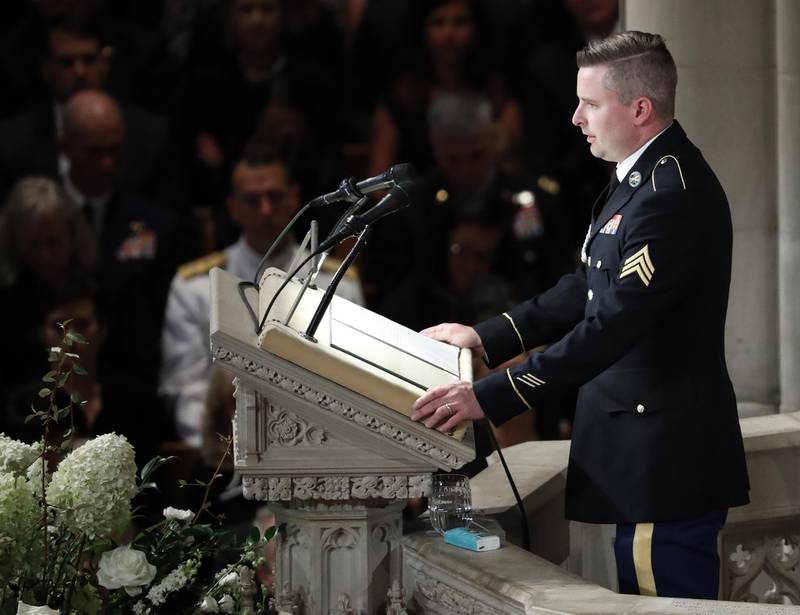 Jimmy McCain reads the poem “The Requiem,” at a memorial service for his father at Washington National Cathedral. AP