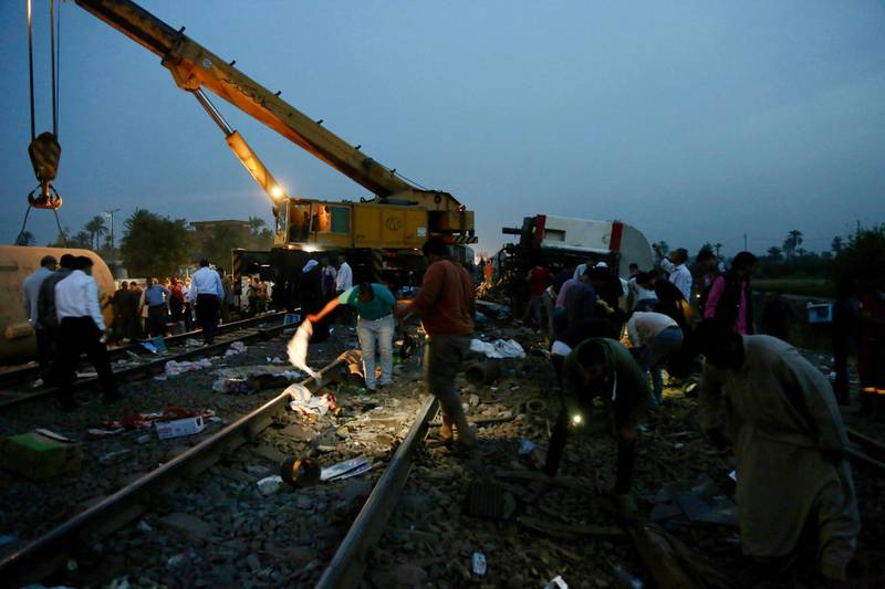 People search for belongings in the aftermath of a passenger train that derailed injuring around 100 people, near Banha, Qalyubia province, Egypt. AP Photo