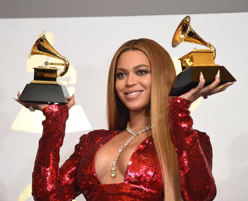 (FILES) In this file photo taken on February 12, 2017 Singer Beyonce poses with her Grammy trophies in the press room during the 59th Annual Grammy music Awards in Los Angeles, California.  Keen to keep viewers glued to the Grammys, the Recording Academy has asked the music world's powerhouse performers to anchor yet another awards gala forced to go virtual. Megan Thee Stallion, Cardi B, BTS, Taylor Swift, Dua Lipa and Billie Eilish are among the long list of musicians who will appear during the mix of live and pretaped performances on March 14, 2021. / AFP / Robyn BECK                         
