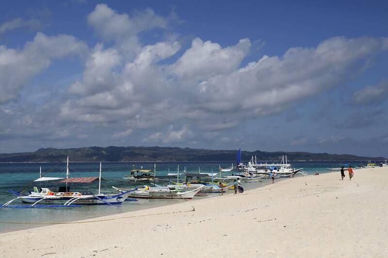 FILE PHOTO: Traditional boats line up the shore in a secluded beach on the island of Boracay, central Philippines January 18, 2016.    REUTERS/Charlie Saceda/File Photo