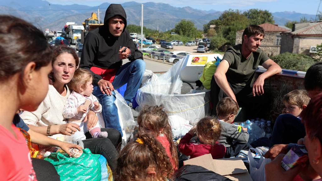 Refugees flee Nagorno-Karabakh after Azerbaijani forces take control