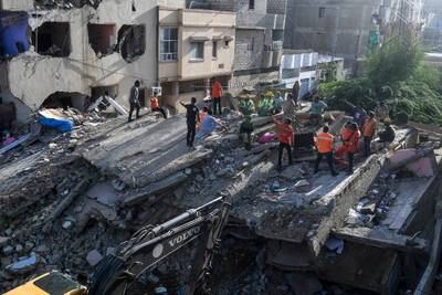 Rescue workers at a collapsed residential block in Karachi in 2020. Five people were killed when a three-storey building collapsed in the southern Pakistan city on Wednesday. AFP