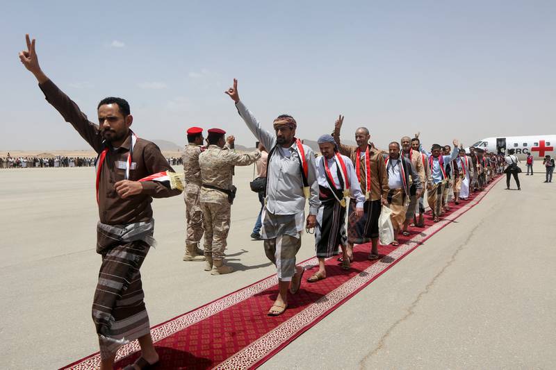 Freed prisoners exit an International Committee of the Red Cross-chartered plane at Marib Airport, Yemen, on April 16. Reuters