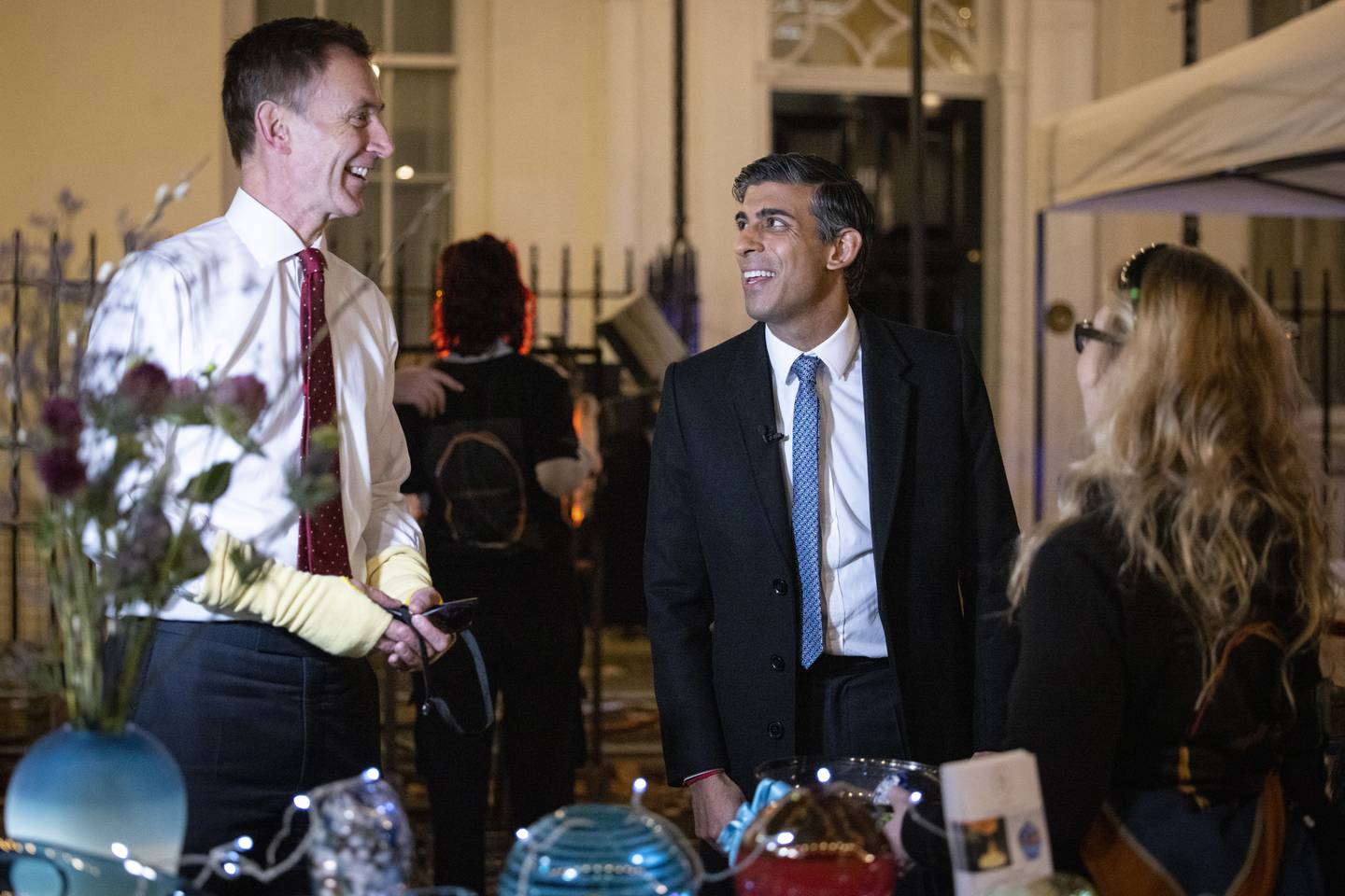 British Prime Minister Rishi Sunak chats with British Chancellor of Exchequer Jeremy Hunt (left) as they meet business owners at a Christmas market in Downing Street in London. EPA
