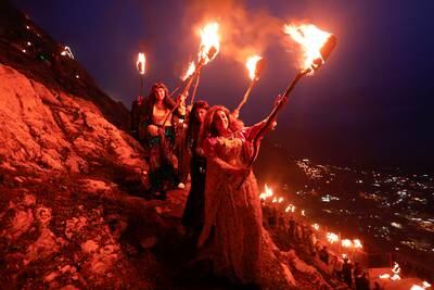 Iraqi Kurdish people carry fire torches, as they celebrate Nowruz Day, a festival marking the first day of spring and Persian New Year, in the town of Akra near Duhok, in Kurdistan. Reuters