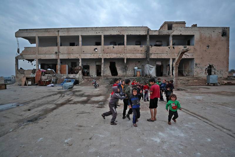 Children of displaced families living in an abandoned, damaged school building in Idlib play together. The school was heavily damaged in fighting between rebels and regime forces. AFP