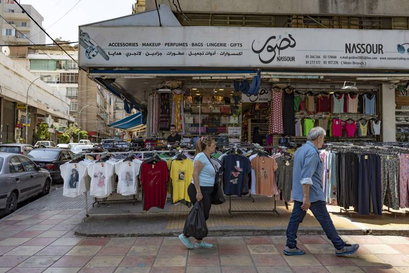 Shoppers pass a clothing store in the Burj Hammoud district of Beirut, Lebanon. Bloomberg