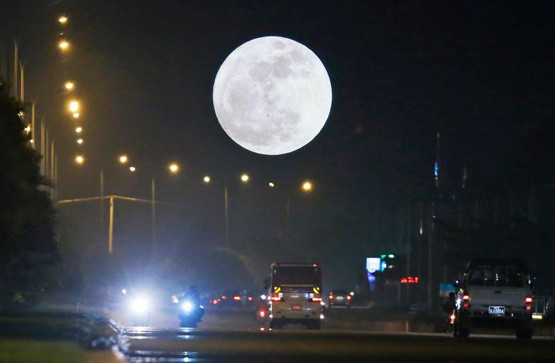 A so-called 'Supermoon' dominates the sky while traffic rolls in the streets in Naypyitaw, Myanmar. Hein Htet / EPA
