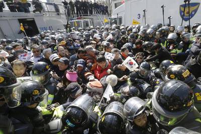 Supporters of South Korean president Park Geun-hye are blocked by police officers as they march toward constitutional court in Seoul after a rally opposing her impeachment over a corruption scandal. Ahn Young-joon / AP / March 10, 2017.