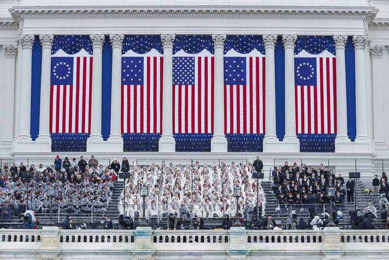 Members of the Mormon Tabernacle choir sit on the west front of the US Capitol as rain begins to fall on January 20, 2017, several hours before Donald Trump is sworn in as the 45th president of the United States in Washington, DC. Shawn Thew / EPA