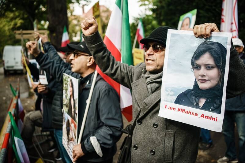 Protesters from the National Council of Resistance of Iran hold pictures of Mahsa Amini in front of the Iranian embassy in Berlin last month. EPA
