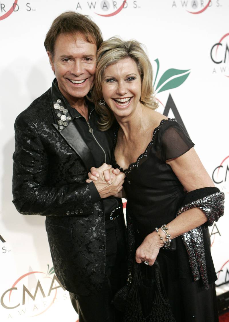 Newton John with British recording artist Cliff Richard for the 39th Annual Country Music Association Awards in New York, 2005.  AP 