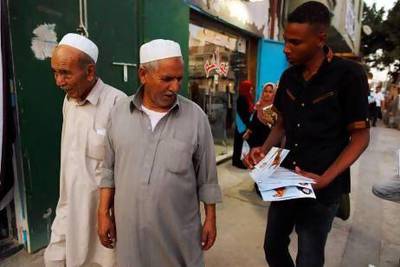 A member of the Justice and Construction Party, the political arm of the Libyan Muslim Brotherhood, hands out brochures at the July election.