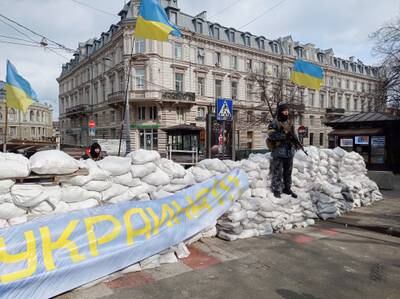 A soldier stands on a barricade made of sandbags in central Odesa, Ukraine. Reuters