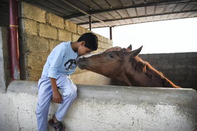 Muatassim Al Maskari, 10, proudly calls his horse his friend. Courtesy of David Ismael