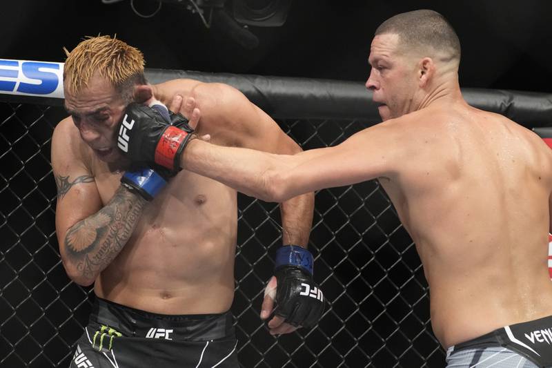 Nate Diaz hits Tony Ferguson during their welterweight bout at UFC 279. AP