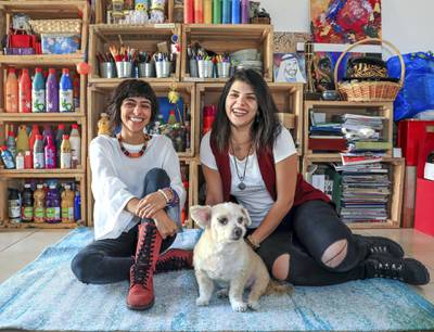 Abu Dhabi, U.A.E., February 2, 2019.   Christina (right) and Tanya Awad with their dog Brownie, have brought together hundreds of people since they launched their indie arts and culture initiative, Blank Canvas Community. Victor Besa/The NationalSection:  WKReporter:  Nathalie Farah