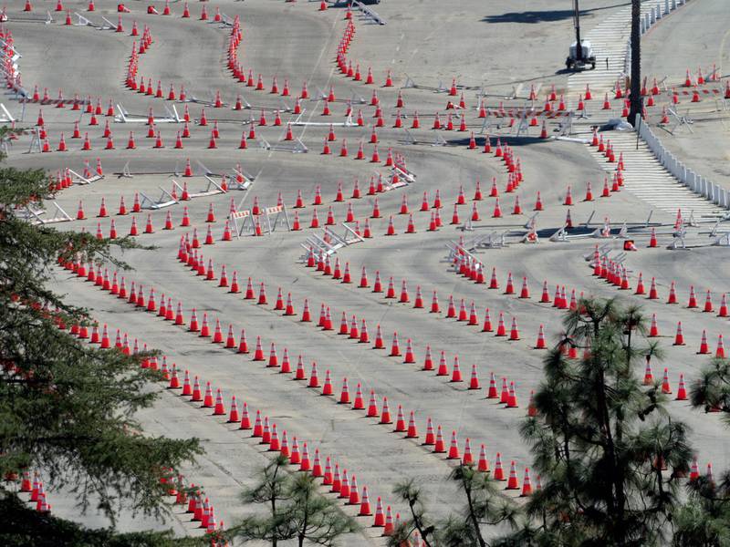 Traffic cones line around the empty parking lot of Dodger Stadium, a mass COVID-19 vaccination in Los Angeles. California has closed some vaccination centers and delayed appointments following winter storms elsewhere in the country that hampered the shipment of doses. AP Photo