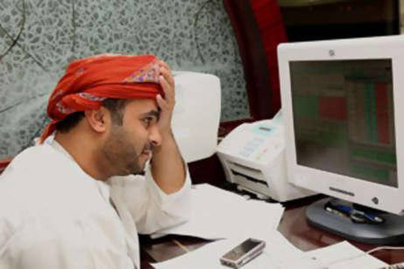 A Omani investor follows share values at the stock exchange in the Omani capital Muscat on Oct 9 2008.