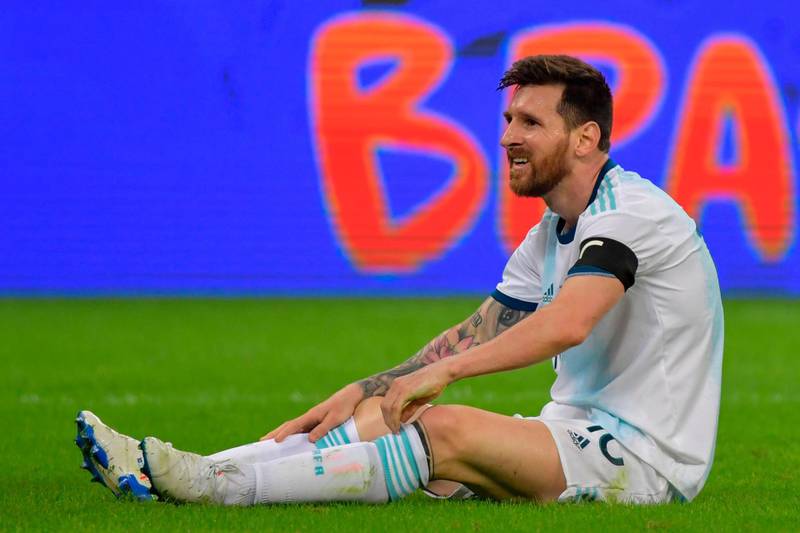 Argentina's Lionel Messi sits on the ground after being fouled. AFP