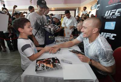 United Arab Emirates - Abu Dhabi - April 09 - 2010 : UFC fighter georges rush st-pierre shake hands with a fan while sign autograph at Marina Mall.  ( Jaime Puebla / The National )