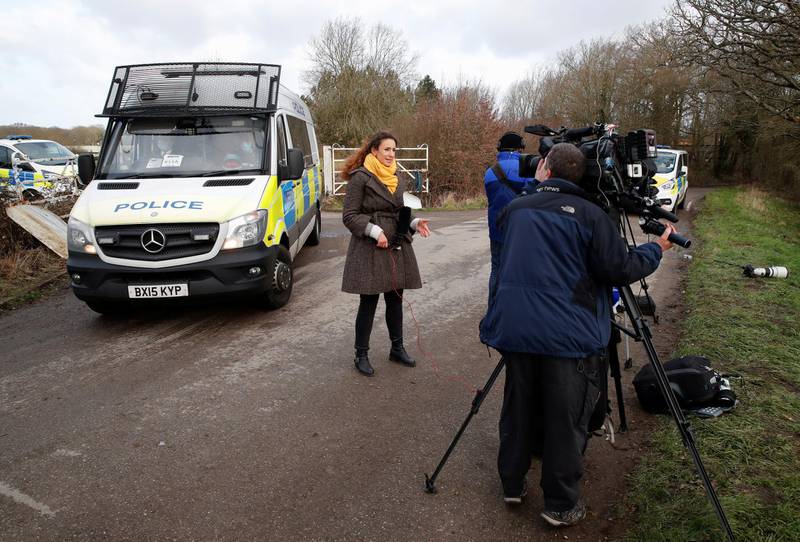 Members of the media and police vehicles are seen at the Great Chart Golf and Leisure Country Club in Ashford. Reuters
