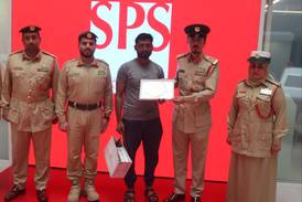 Mohammed Riyadh, a driver, was given a gift by Dubai Police after handing in cash he found in his car. Photo: Dubai Police