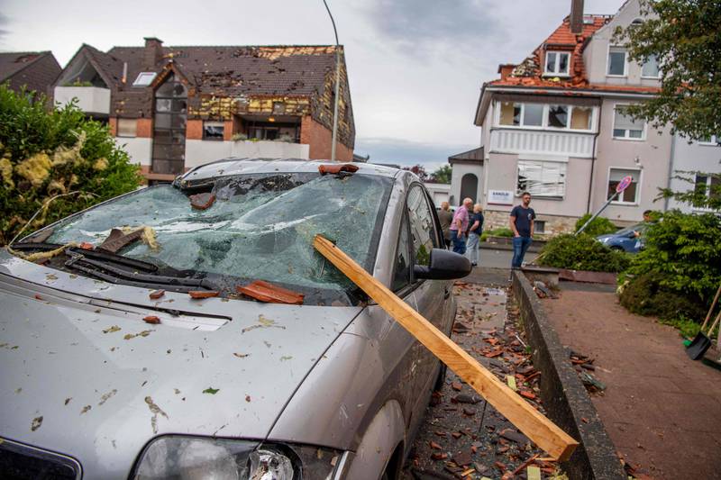 A roof batten is stuck in the windshield of a parked car in Paderborn, western Germany, following a tornado. AFP