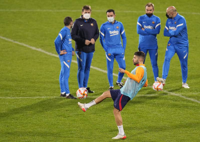 Barcelona's Jordi Alba controls the ball in front Barcelona's head coach Xavi. AP Photo