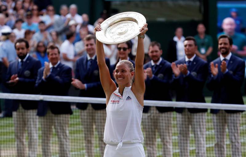 Tennis - Wimbledon - All England Lawn Tennis and Croquet Club, London, Britain - July 14, 2018  Germany's Angelique Kerber celebrates winning the women's singles final with the trophy   REUTERS/Andrew Boyers