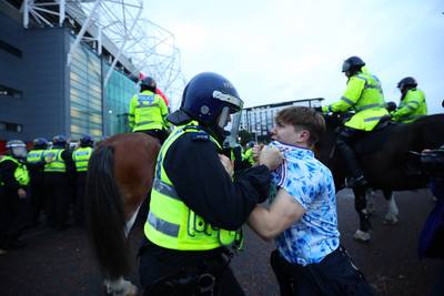 Ryan Jenkinson's picture of police arresting a Manchester United fan during a protest against the club's owners has been shortlisted in the Young Photographer of the Year category