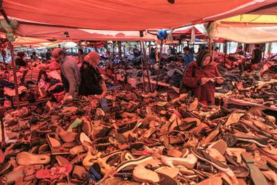 Shoppers browse shoes for sale at a second-hand clothing market in the Ettadhamen district of Tunis, on April 8, 2022.  Photo: Bloomberg