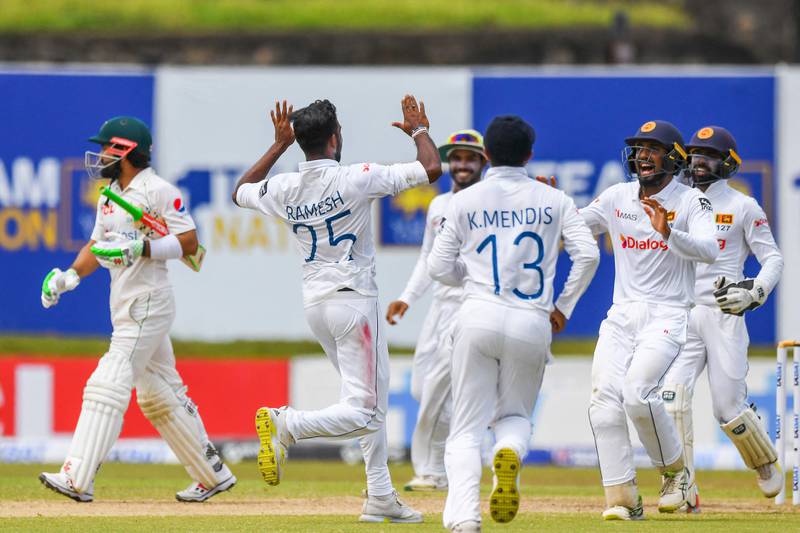 Sri Lanka's Ramesh Mendis celebrates with teammates after taking the wicket of Mohammad Rizwan. AFP