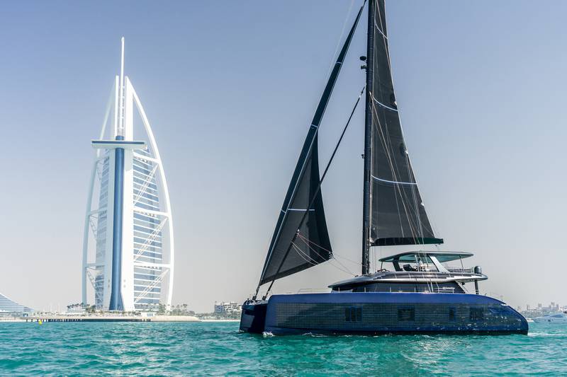 An all-electric luxury 80-foot catamaran sails past Dubai’s Burj Al Arab.
