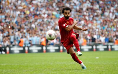 Mohamed Salah scores a penalty during the shoot-out. Reuters