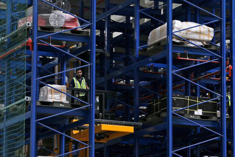 An employee of Emirates SkyCentral uploads goods at the new facility. Kamran Jebreili / AP Photo