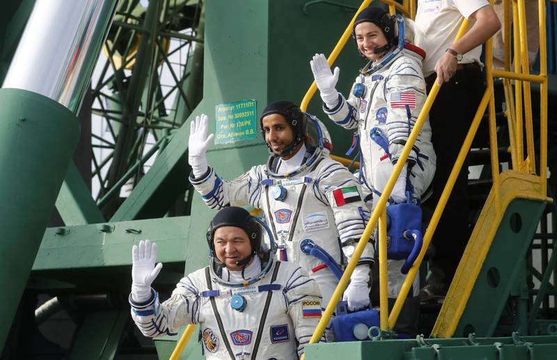 International Space Station (ISS) crew members UAE astronaut Hazza Al Mansouri (C), Roscosmos Russian cosmonaut Oleg Skripochka (bottom) and NASA's US astronaut Jessica Meir (top) board the Soyuz MS-15 spacecraft before its blasts off for the ISS, on September 25, 2019 at the Russian-leased Baikonur cosmodrome in Kazakhstan.  / AFP / POOL / Maxim SHIPENKOV
