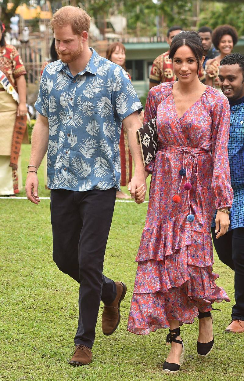 Meghan, Duchess of Sussex wears a Figue dress and Castaner wedges at the University of the South Pacific in Suva on October 24, 2018. AFP
