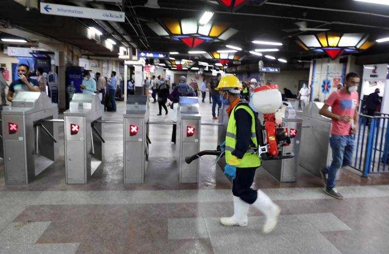A worker sprays disinfectants at underground Al Shohadaa metro station in Cairo, Egypt.  EPA