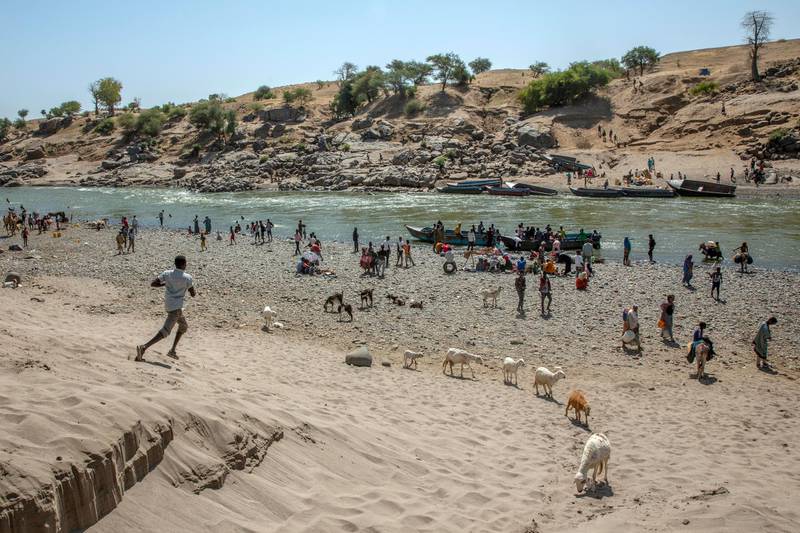 Tigray refugees who fled the conflict in the Ethiopia's Tigray arrive on the banks of the Tekeze River on the Sudan-Ethiopia border, in Hamdayet, eastern Sudan. AP Photo