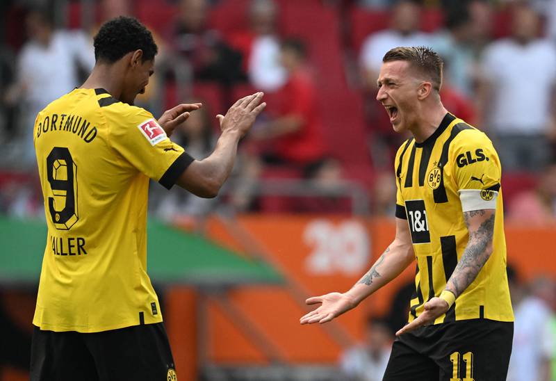 Dortmund forward Sebastien Haller  celebrates with his teammate Marco Reus. AFP