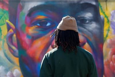 A person pays his respect at a mural of George Floyd after the verdict in the trial of former Minneapolis police officer Derek Chauvin, found guilty of the death of Floyd, in Denver, Colorado. Reuters