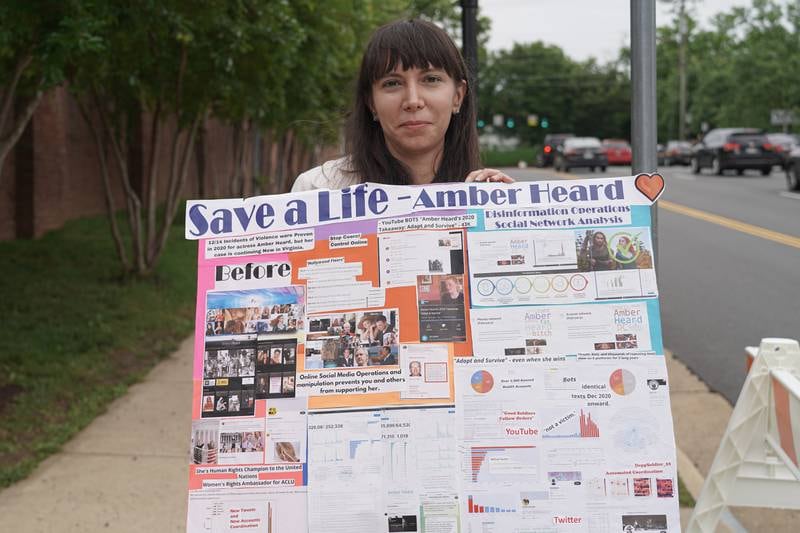 Christina Taft holds up poster in support of actress Amber Heard outside the Fairfax County Courthouse in Fairfax, Virginia. Willy Lowry / The National