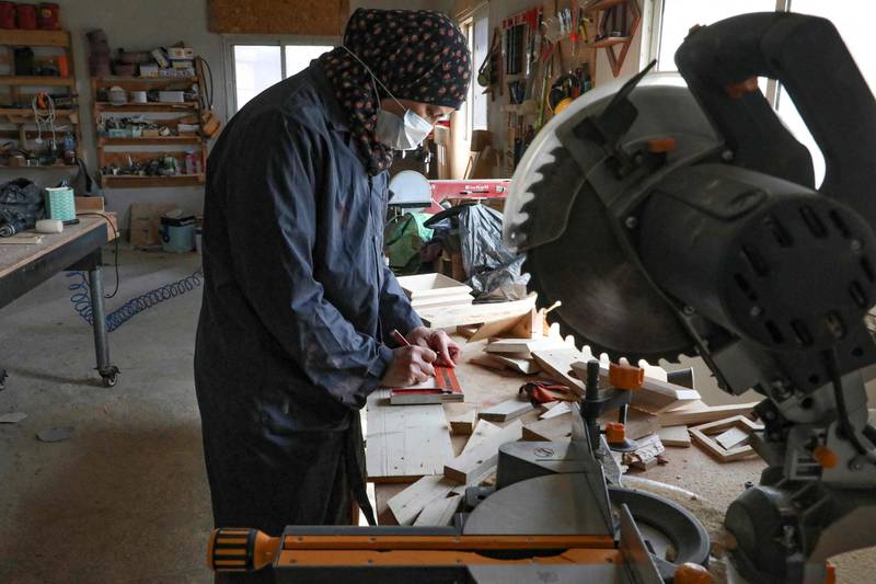 A Palestinian woman works at a carpenter workshop, established and run by a group of women, in the village of Al Walajeh near the West bank town of Bethlehem. AFP