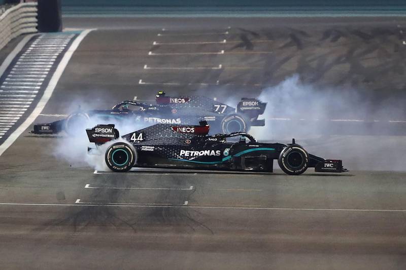 Mercedes' Finnish driver Valtteri Bottas and teammate Lewis Hamilton do doughnuts after the race.  AFP