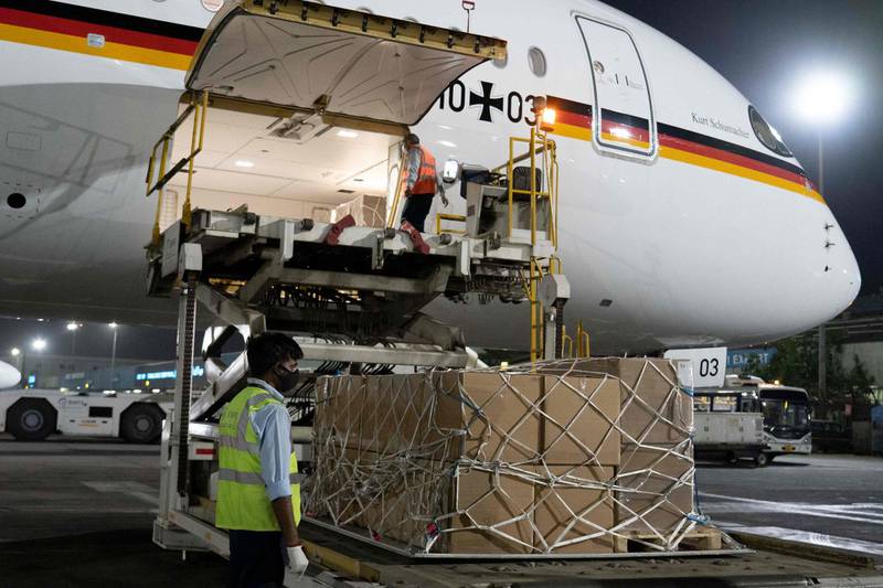 A ground staff unloading the Covid-19 coronavirus medical aid supplies from Germany, at an airport in New Delhi. AFP