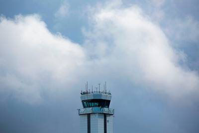 A person (centre) is silhouetted in the airport control tower after the first flight event for the Boeing 777X airplane had to be rescheduled due to weather at Paine Field in Everett, Washington on January 24, 2020. AFP