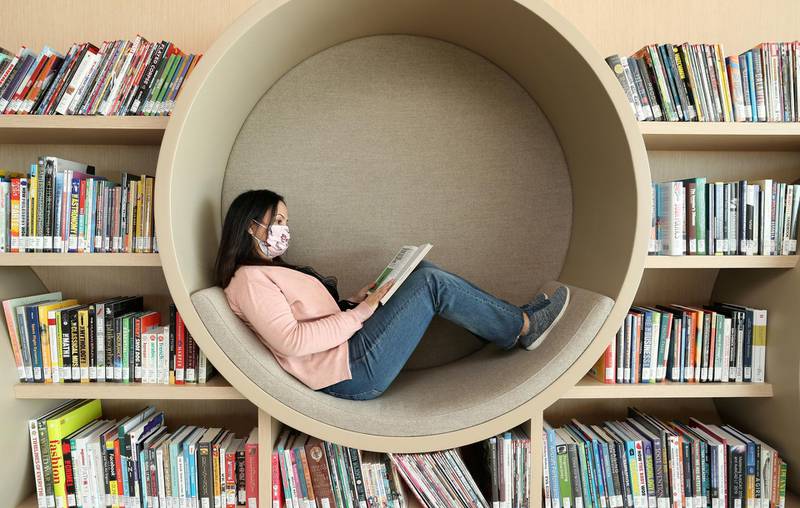 Sharjah, United Arab Emirates - December 10, 2020: News. Arts. Ebtisam Kasabri reads a book in a pod. Opening of the House of Wisdom, a high tech new library. Thursday, December 10th, 2020 in Sharjah. Chris Whiteoak / The National